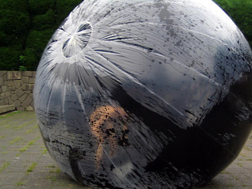 The transparent bubble becomes completely black, concealing the artist within. 